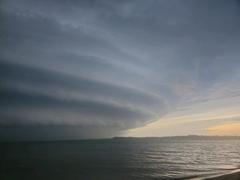 dramatic cloud formation over the sea at sunset