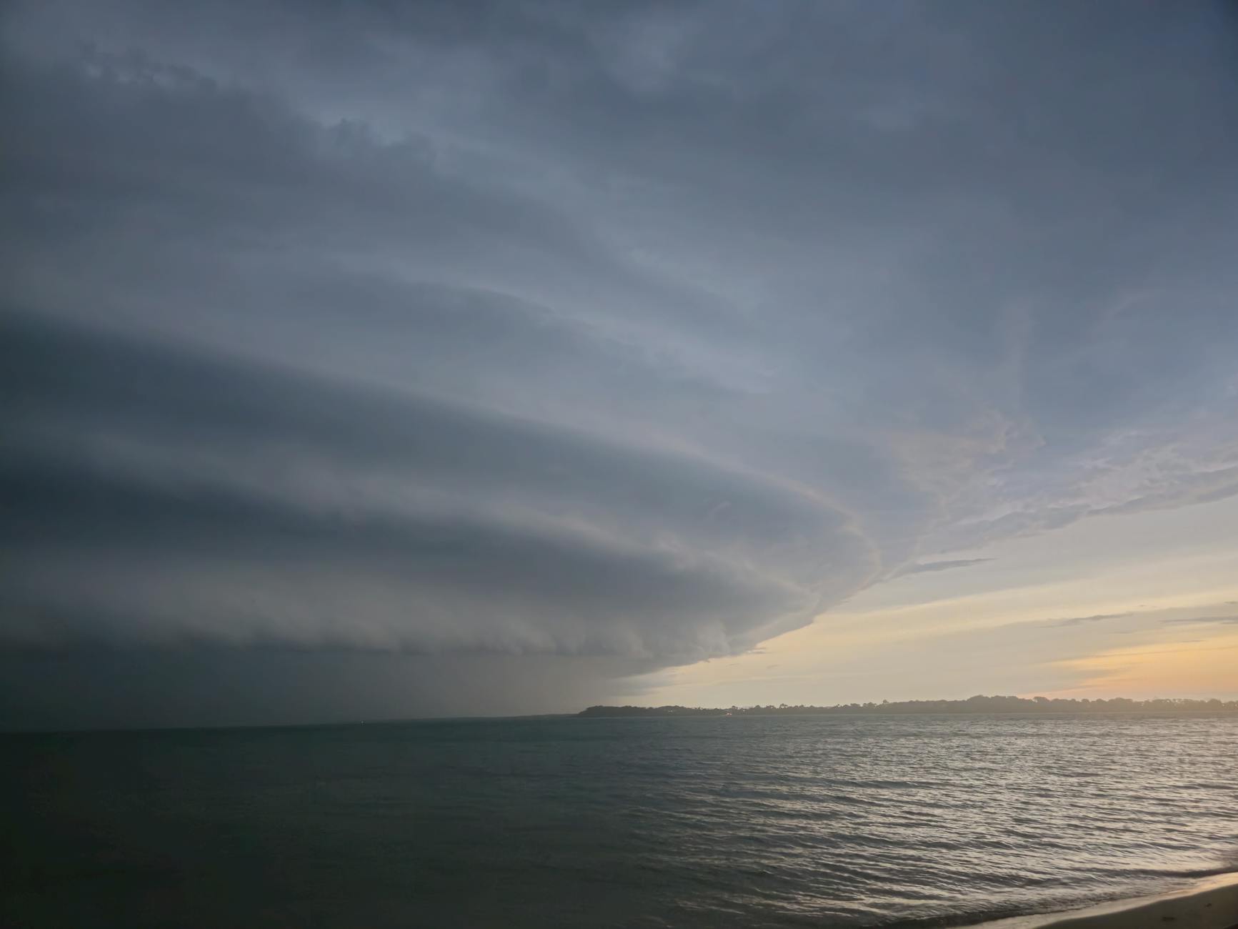 dramatic cloud formation over the sea at sunset