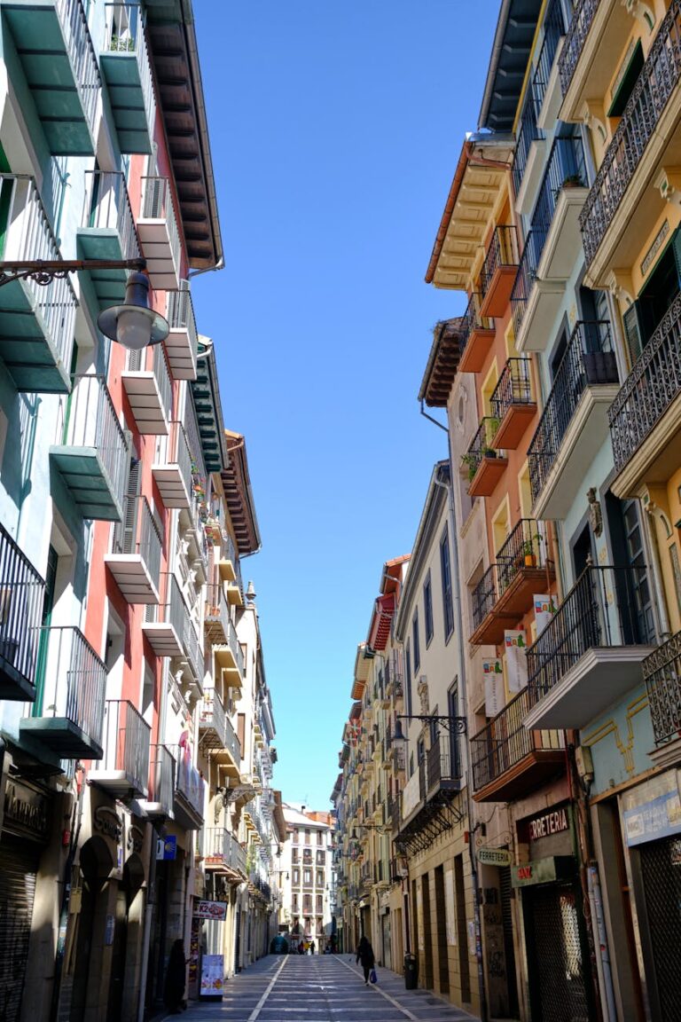 a street between residential buildings in city