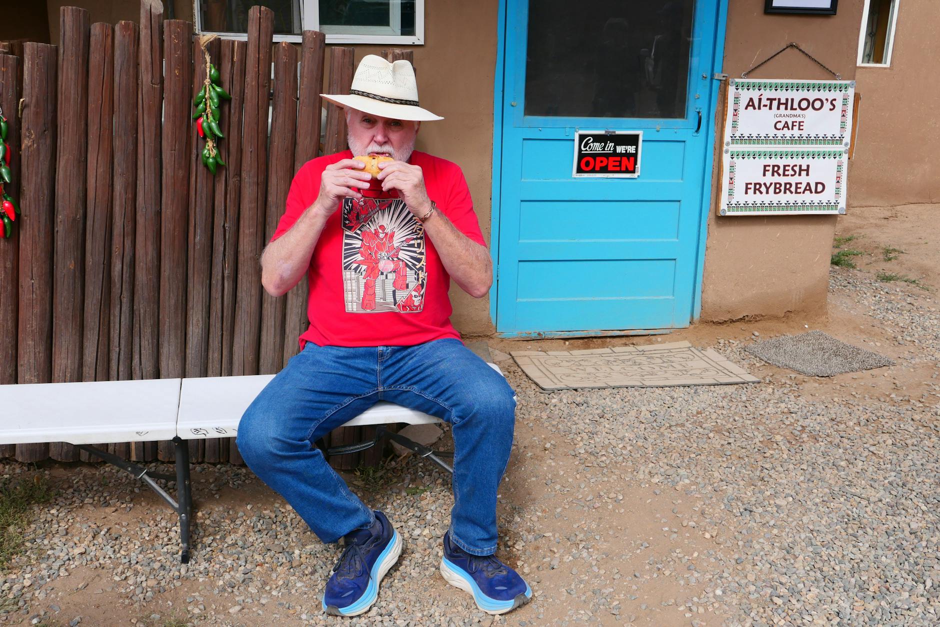 man enjoying fresh frybread at taos pueblo cafe