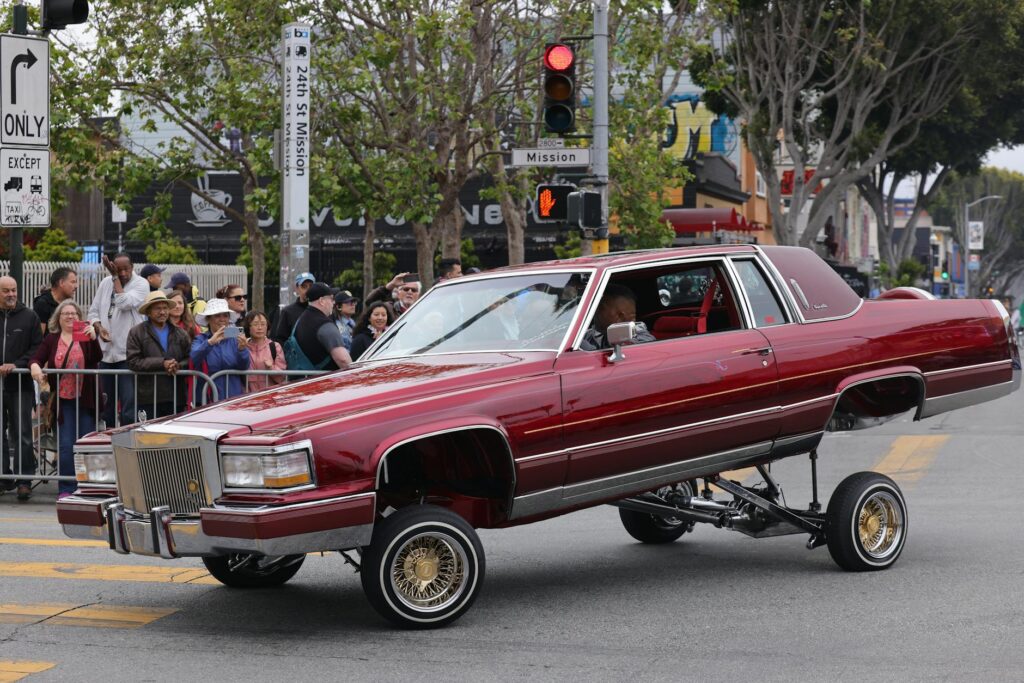 a lowrider cadillac fleetwood on the street