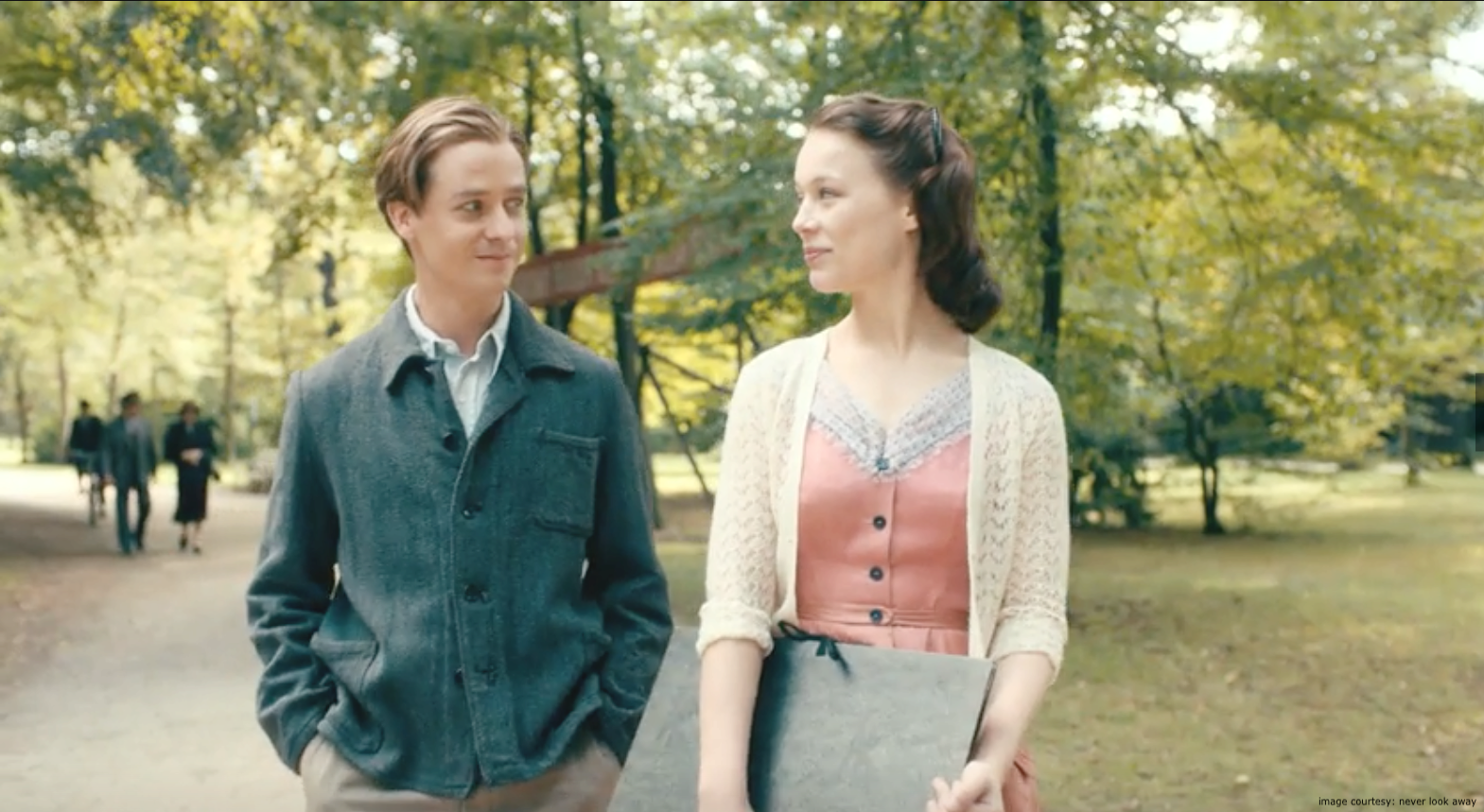 Never Look Away film still of Kurt Barnert (Edward Schilling) and Ellie Seeband (Paula Beer) on there first date walking in the park