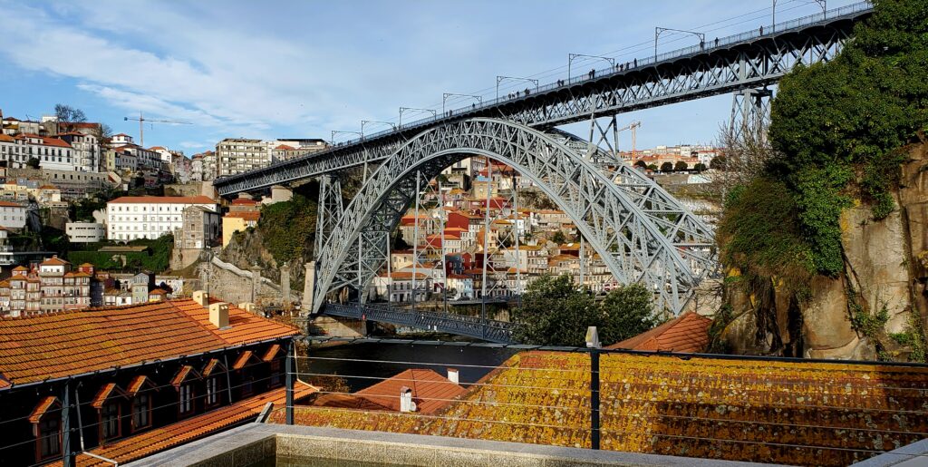Upper and lower decks of the Dom Luís I Bridge viewed from a rooftop in Porto