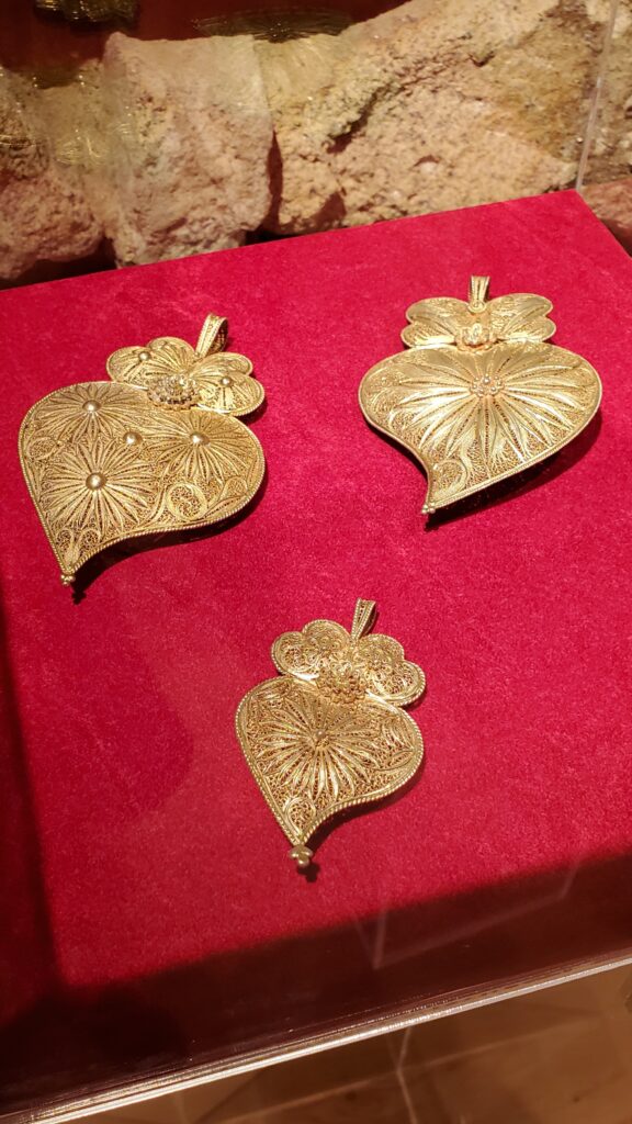 Traditional Portuguese gold filigree jewelry on display at The House of Filigree in Porto
