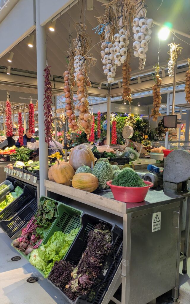 Colorful market stalls with fresh garlic and vegetables in Portugal