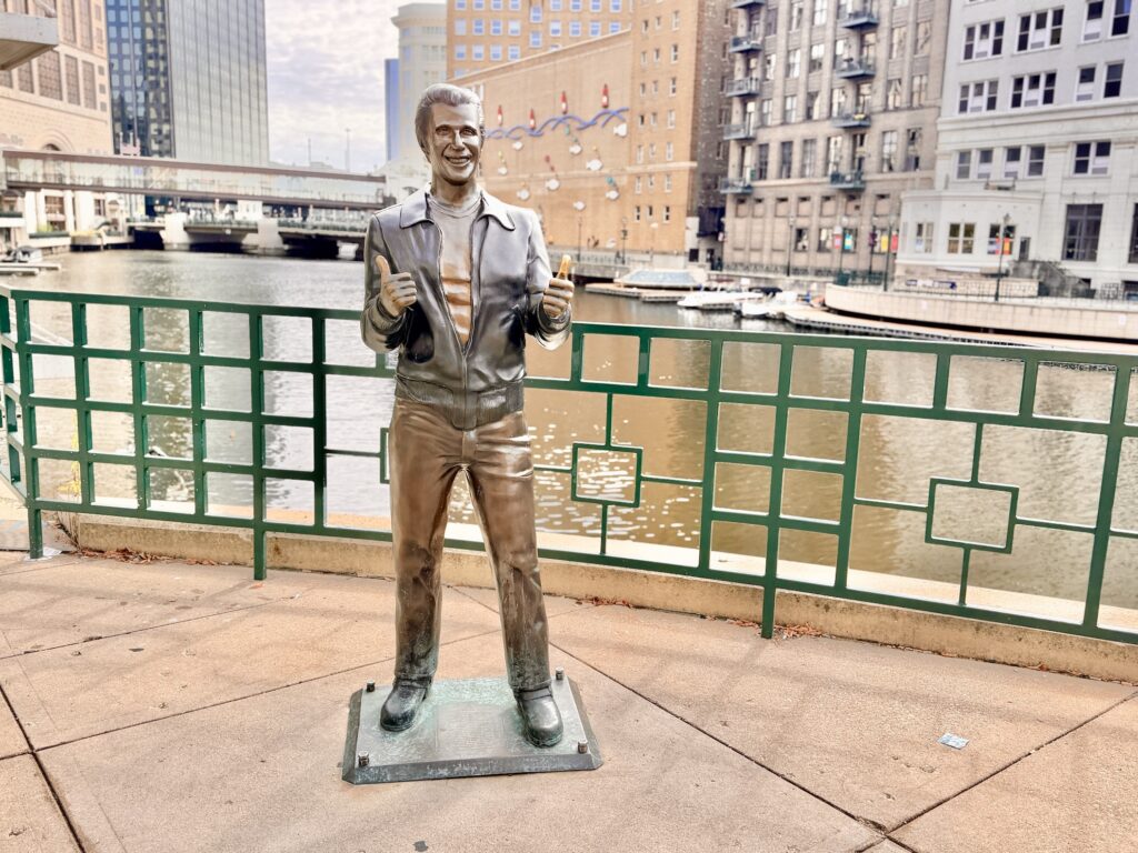 a statue featuring the actor Henry Winkler as The Fonz, from a 1970's era tv show