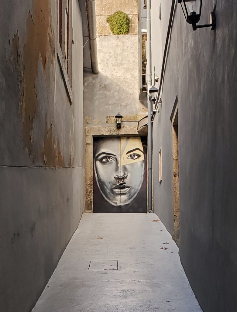 Street art mural in a narrow alley in Porto