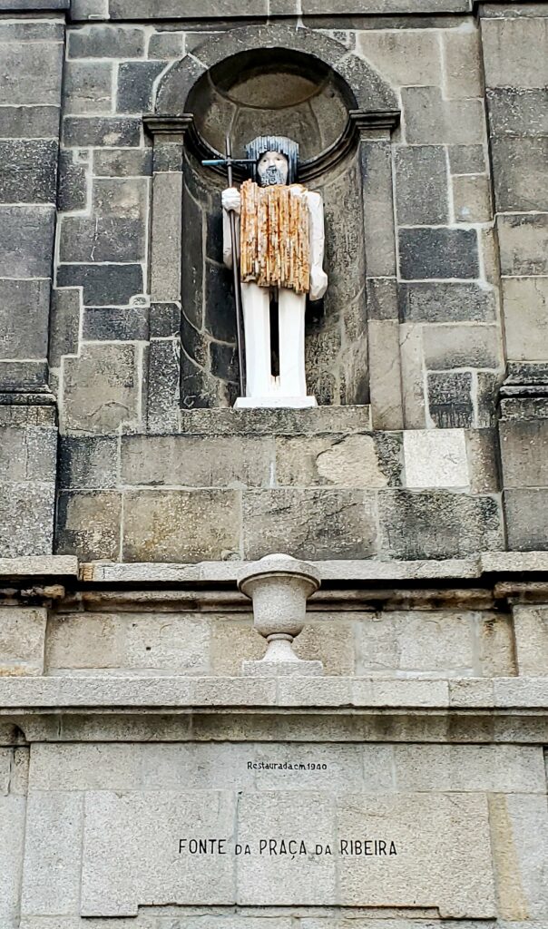 Stone statue on a historic church facade in Porto